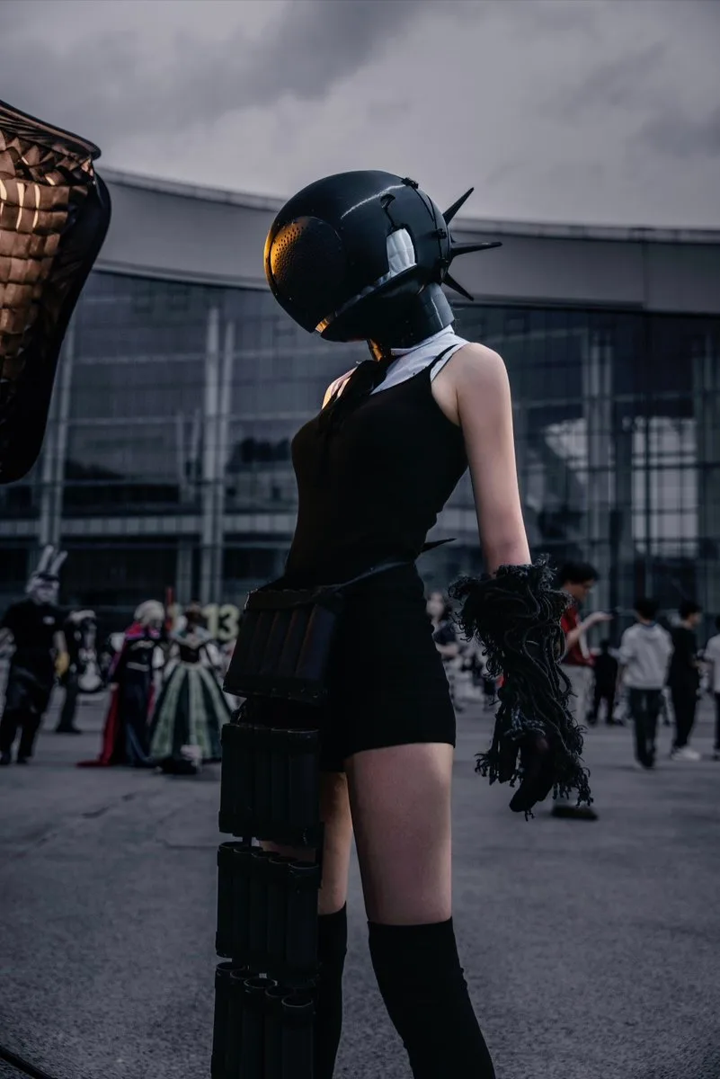 Futuristic black helmet and costume at an outdoor event